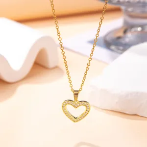 Macro detail of gold-plated heart pendant encrusted with cubic zirconia