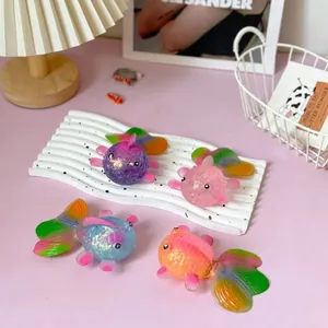 Colorful goldfish-shaped slow rebound squishy fidget toys arranged on a white tray
