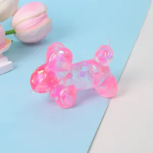 Close-up of a pink iridescent balloon dog squishy toy with glitter sequins inside