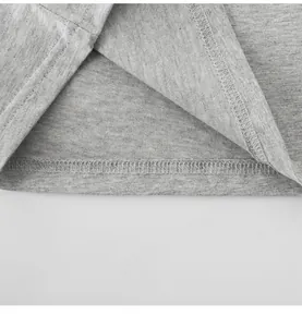 Close-up macro view of the double-stitched hem on a grey cotton children's t-shirt.