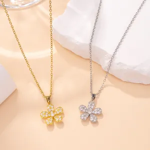 Minimalist flower pendant necklace with pavé crystal accents in gold and silver tones