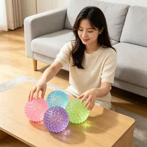 Four colorful maltose diamond sensory stress relief squeeze balls in a home setting