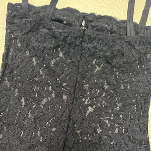 Close-up showing the intricate black floral lace pattern on this elegant dress