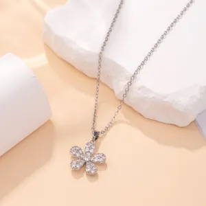 Macro view of a sparkling silver-toned flower pendant necklace with clear crystals