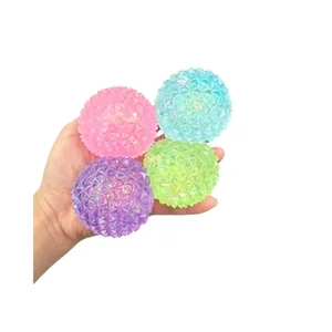 Set of colorful diamond-textured squishy stress balls held in hand for sensory relief