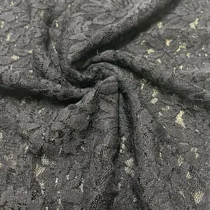 Detailed macro view of black sheer lace fabric with elegant rose floral patterns
