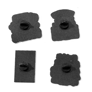 Detailed back view of four medical-themed enamel pins with black rubber clutches