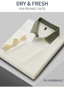 Detailed view of off-white men's Polo shirt with green contrast ribbed collar.