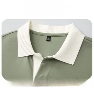 Detail of a men's polo shirt featuring a white rib-knit seagull collar on olive green fabric
