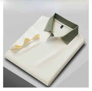 Detail view of a men's cream Polo shirt with olive green contrast seagull collar.