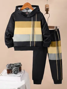 Detailed view of kids' black hooded sweatshirt and pants with color-block stripes