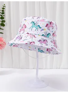 Detail view of white toddler bucket hat with vibrant unicorn and star patterns