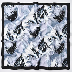 Close-up of elegant floral print square scarf with blue and black abstract petal patterns