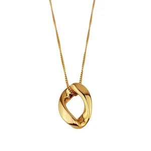 Minimalist gold necklace with a unique irregular hollow oval pendant on a fine chain.