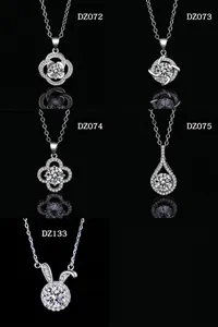 Multiple minimalist moissanite-style pendant necklaces in silver finish on black background