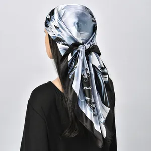 Elegant floral print silk-like square scarf worn as a headscarf shown from the back