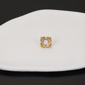 Close-up of French style 18k gold stainless steel stud earring with elegant shell inlay detail.
