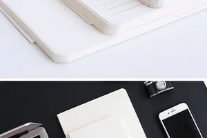 Close-up of minimalist white notebook refills with lined and blank pages on a modern desk.