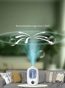 Close-up detail of automatic scent diffuser spraying mist vertically in living room