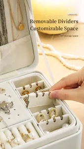 Detail view of a luxury jewelry box showing the functional removable dividers feature.