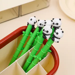 Close-up detail of cute panda figurines atop bamboo-shaped green gel pens
