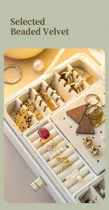 Detailed view of multi-layer jewelry box interior with velvet lining and ring slots