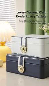 Luxury leather jewelry organizer boxes with sparkling diamond buckles in white and navy.