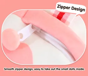 Close-up detail of smooth white zipper on pink plush crossbody bag