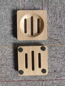 Detail view of square bamboo soap dish showing drainage slots and non-slip bottom pads