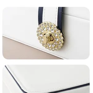 Close-up of high-end jewelry box with luxury diamond buckle and fine stitching detail.