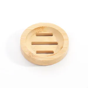 Detailed top view of a round natural bamboo soap dish featuring three drainage slots