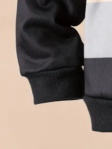 Detail view of ribbed cuffs on a 2025 color-block striped casual hooded sweatshirt