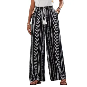 Pantaloni a gamba larga a vita alta da donna con stampa geometrica e nappe decorative
