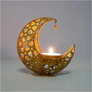 Detailed view of a golden crescent moon candle holder with hollow star cutouts and a tealight