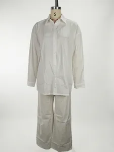 Detail of a white long-sleeved shirt and wide-leg trousers casual lounge set for women.