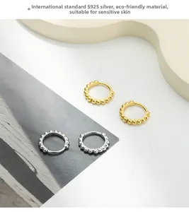 Close-up of S925 sterling silver vintage beaded hoop earrings in gold and silver finish