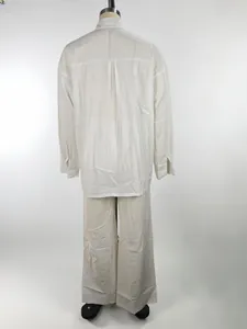 Back view of white long-sleeve loose shirt and wide-leg trousers set for women