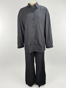 Elegant black two-piece women's set featuring long-sleeve shirt and wide-leg trousers.