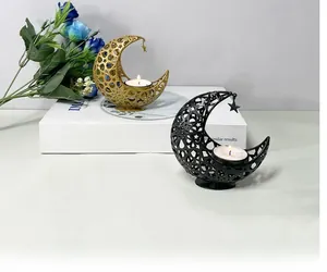 Detailed close-up of decorative hollow metal moon candle holders with star pendants
