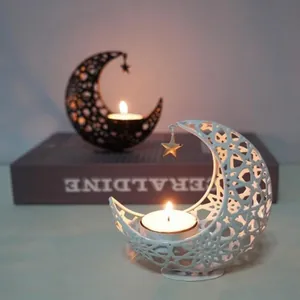 Elegant crescent moon hollow metal candle holder with warm lit tea light candles