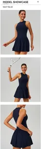 Detailed close-up of navy blue tennis dress featuring a pleated skirt and zipper collar