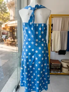 Detailed back view of retro blue and white polka dot halter neck dress for women