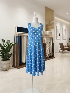 Vintage blue and white polka dot halter dress shown on a white display mannequin