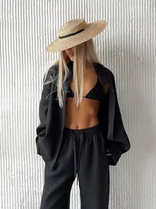 Detailed view of women's black loose linen shirt and trousers three-piece leisure set