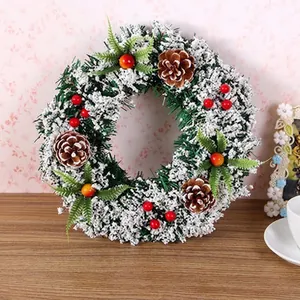 Artificial Christmas wreath with pine cones red berries and faux snow detail