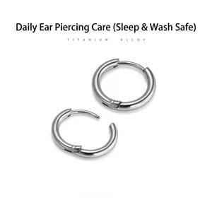 Detail of titanium alloy hoop earrings showing smooth finish and secure clasp mechanism