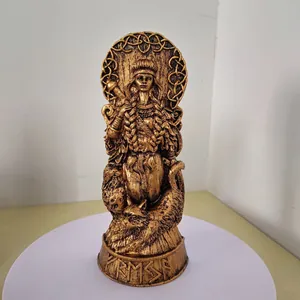 Detailed close-up of golden Nordic goddess resin statue with intricate runic base