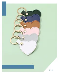Detailed view of six colorful heart-shaped faux leather keychains with golden metal rings