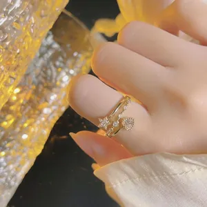 Elegant gold ring featuring a sparkling heart-shaped stone and a diamond-studded star.