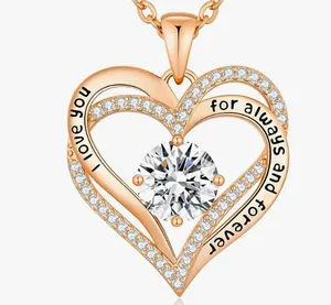 Close-up of elegant rose gold double heart pendant with engraved I love you message